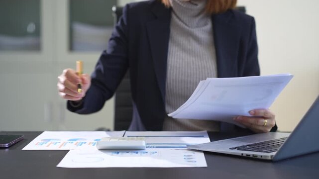 Business women using calculator with computer laptop, Business accounting, budget and loan paper in office.