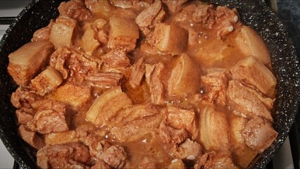 Frying pork meat with spices in a hot frying pan. fried meat in a frying pan. cooking
