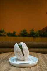 Placed on a white ceramic plate on a wooden table, captured indoors with a warm blurred background.