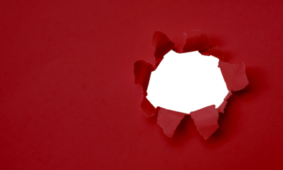 Torn red paper with a hole in the sides and space to insert text. Suitable for use in marketing media to promote advertising content.