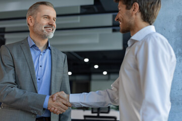 Businessmen shaking hands during a meeting.