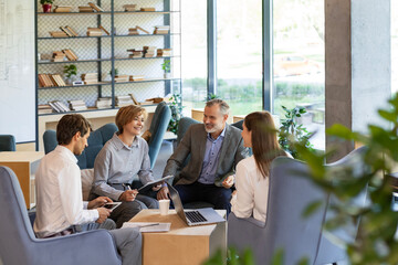Business team discussing together business plans in office.