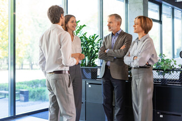 Business team discussing together business plans in office.