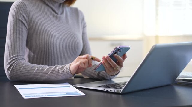 Business woman working on laptop and accounting financial report, accountant using calculator to calculate tax refund at office