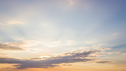 Fototapeta premium Bright Sky with Sunbeams and Scattered Clouds at Dawn