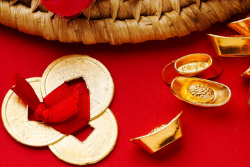 Golden Ingots and Chinese Coins on a Red Background for Lunar New Year