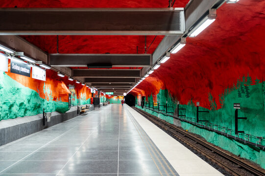 Solna centrum, 15 May 2024: A person walks on the platform of the vibrantly decorated Solna centrum metro station.