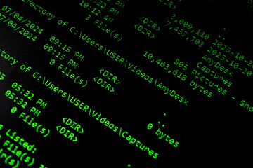 Close-up view of a computer screen displaying directory listings in green text on a black background.