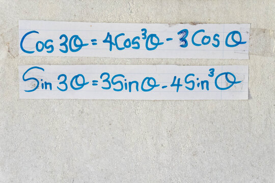 Trigonometric identities handwritten on a white surface.