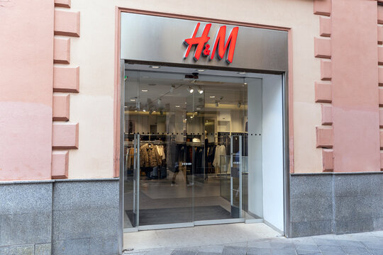 Seville, Spain; October 15, 2025: H&M fashion retail store with logo sign on storefront.
