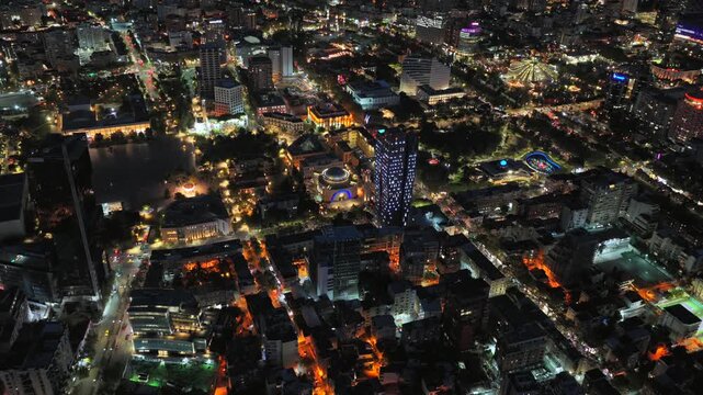 Night aerial video of Tirana showcasing urban streets glowing city lights. 