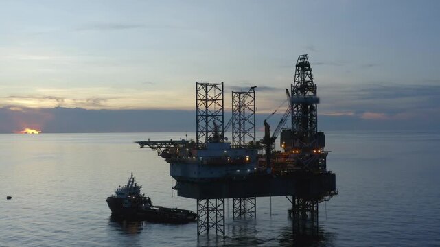 Offshore jack up rig in aerial view in the middle of the ocean taken by a drone
