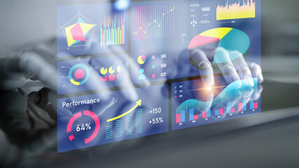Digital analysis of data displayed on a transparent screen with various charts and graphs, representing business performance and decision-making insights. Impute