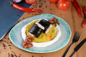 Couscous porridge with vegetables and fish in nori sheets
