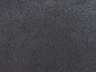 Subtle interplay of black and gray granules on a textured paper surface