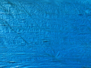 Blue background, texture of fine mesh bundle of braided threads, uneven surface. High quality