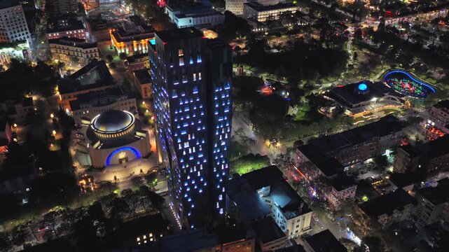 Night aerial video of Tirana showcasing urban streets glowing city lights. 