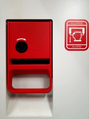 Red fire alarm box on a white background, closeup of photo