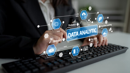 A businesswoman interacts with a data analytics interface, showcasing various technology icons and visual elements related to data analysis in a modern office setting. Tessel