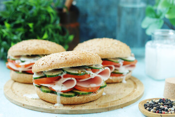 Bun sandwiches with salami and vegetables	