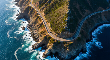 An aerial view of a winding coastal road hugging dramatic cliffs, with the deep blue ocean crashing against the rocky shoreline, illuminated by the bright morning sun.