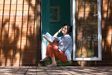 Mindfulness and feel-good moments.  lifestyle portrait smiling middle aged woman reading a book...