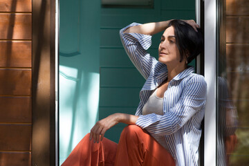 Mindfulness and feel-good moments.  lifestyle portrait smiling middle aged woman is resting sitting...