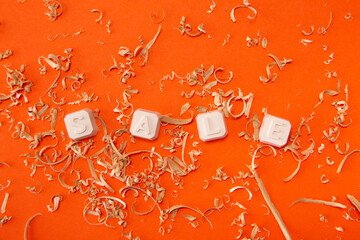 Sale sign on a orange background with sawdust