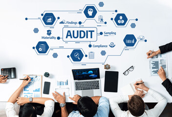 A professional business team collaborating in an audit process, showcasing documents, charts, and...