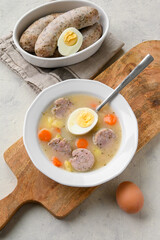 Sour soup with sausage and egg, traditional Polish soup