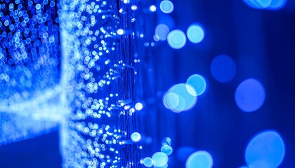 Abstract blurred light displays in deep blue, with visible bokeh on the right