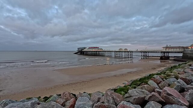 View across Cromer beach towards the Victorian pier on the North Norfolk Coast. Captured late afternoon just before the light disappeared on a cold and cloudy afternoon in December