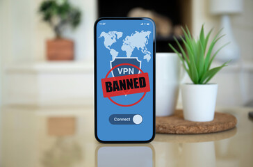 telephone with Vpn banned on screen background fireplace country house