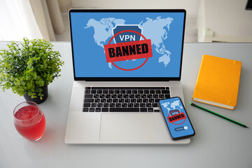 laptop computer and phone with VPN banned on screen office