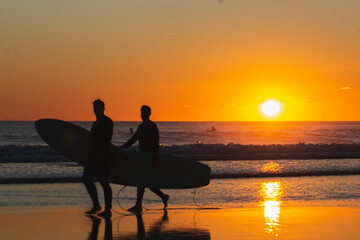 Surfers Walking at Sunset Glow, Caravelos beach, Portugal