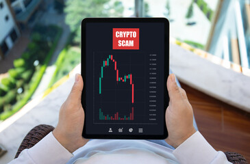 male hands hold computer tablet with chart scam crypto coins