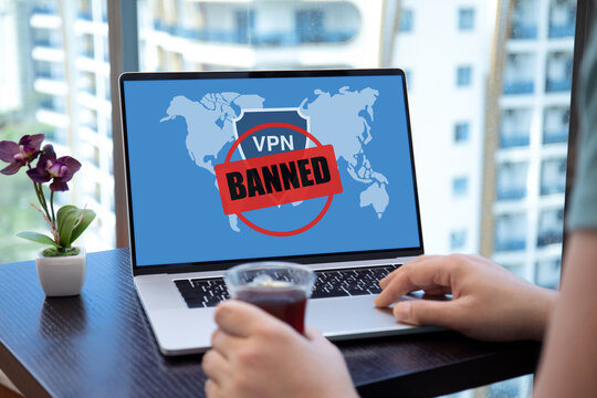 male hands on laptop keyboard with VPN banned on screen