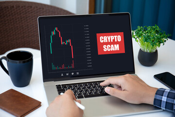 Male hands typing laptop keyboard with chart scam crypto coins