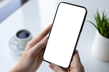 Female hand holding phone with isolated screen over table office