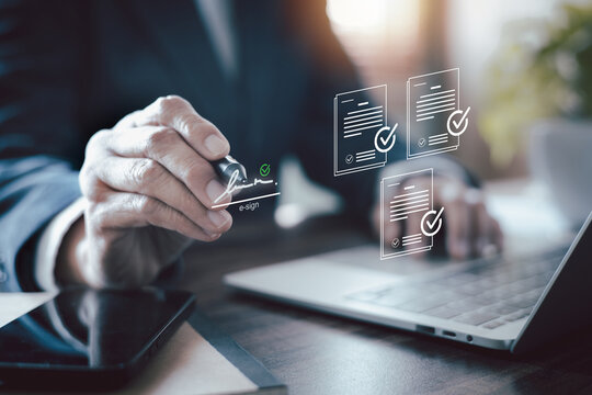 Businessman hand signing electronic signature on virtual document. Concept of e-sign technology, digital contract agreement, paperless office, and online business transaction workflow.