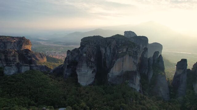 Cinematic Drone Flyover of Meteora Cliffs, Greece. Aerial Cinematic Landscape. Sunset Light throught Meteora.
