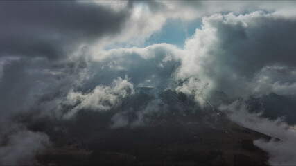 Aerial high view of dramatic clouds and sun