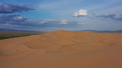 Aerial view of sand dunes in desert at sunset