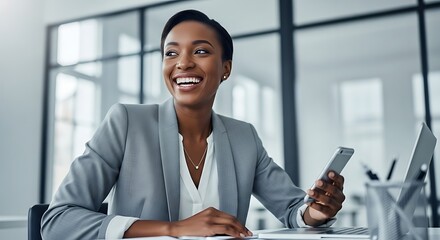 Confident businesswoman smiling while holding a smartphone at her office desk with a laptop