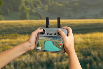 Drone controller displaying mapped land area with measurement overlay, used for surveying, agriculture monitoring, mapping, and precision drone missions © Stanisic Vladimir
