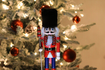 Wooden nutcracker figurine photographed in front of a decorated Christmas tree during a holiday display in Novi Sad on December 6, 2025.
