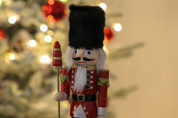 Editorial image of a nutcracker figure photographed beside a decorated Christmas tree in Novi Sad on December 6, 2025.