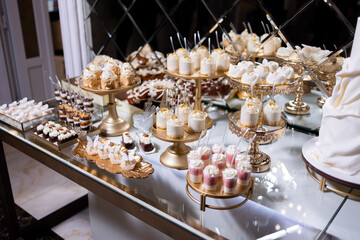 Elegant dessert table with assorted sweets displayed at a lavish event