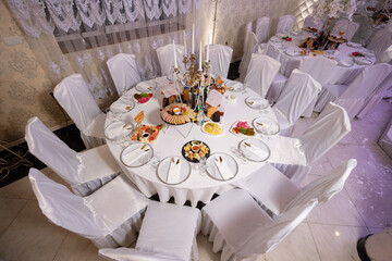 Elegant dining setup with diverse dishes in a decorated venue