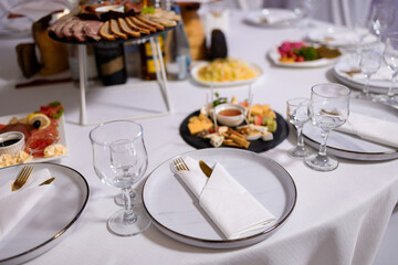 Elegant dining setup with assorted dishes and fine glassware for a special event gathering